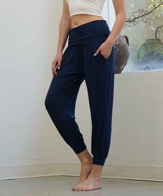 Person wearing navy blue jogger pants against a neutral background