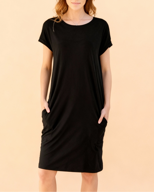 Black dress worn by a person on a beige background